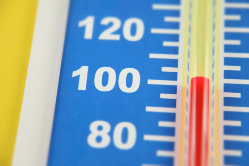 Close up of thermometer hitting the 100 degree mark (Farenheit scale).