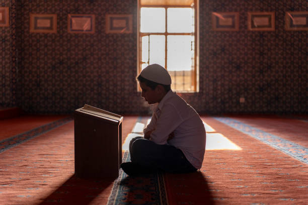 istock A boy reading the Qur'an in a mosque. 1739385637