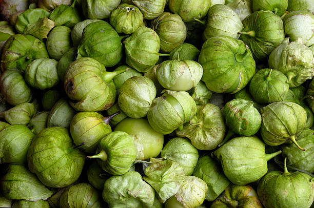 Pile of Tomatillo arranged for sale, in a produce market.