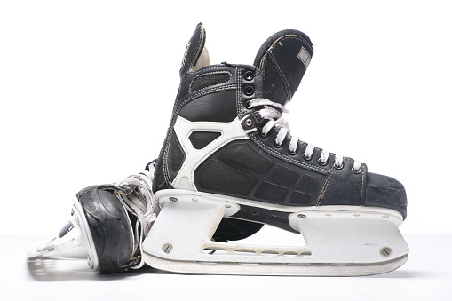 A pair of black and silver ice skates on a white background