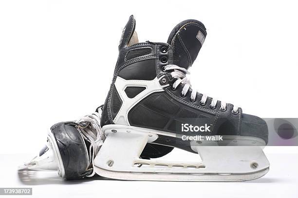 A Pair Of Black And Silver Ice Skates On A White Background Stock Photo - Download Image Now