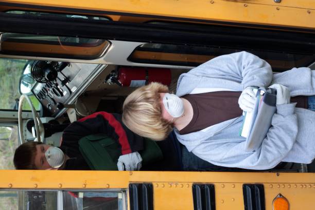 istock Students With Masks and Gloves Getting Off School Bus 173939042