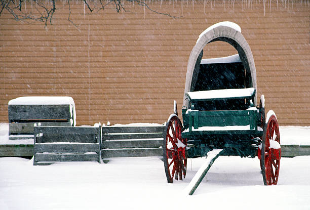 Old Horse Drawn Wagon in the snow with barn-Howard County, Indiana