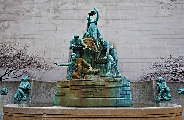 Landmark Chicago Sculpture Spirit of the Great Lakes Fountain: Bronze work of art created by Lorado Taft between 1907-1913. The fountain depicts five women arranged so that, when it is flowing, water passes through them in the same way water passes through the Great Lakes. chicago illinois photos stock pictures, royalty-free photos & images