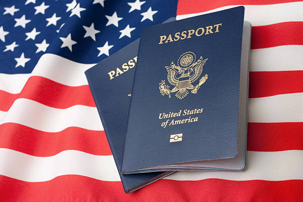 American Identity Symbols U.S. Passports on an American Stars and Stripes flag. passport stock pictures, royalty-free photos & images