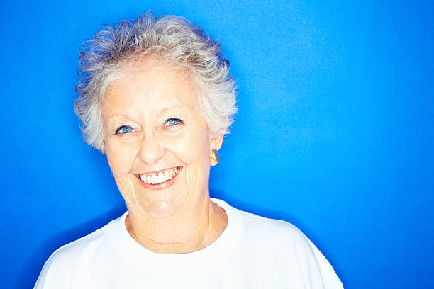 istock Elderly woman isolated over blue background 173940976