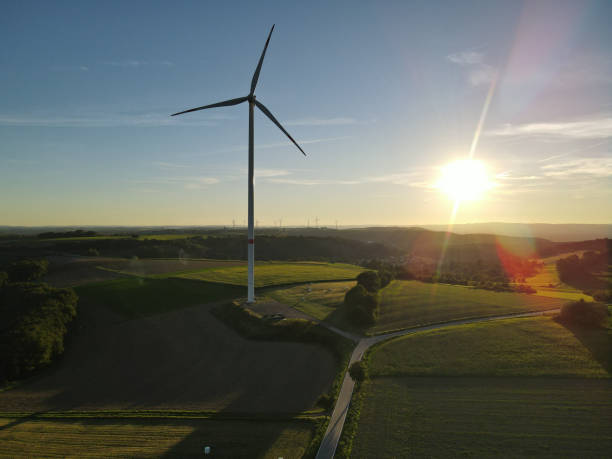 istock Beautiful landscape with a wind turbine during the sunset 1739411051