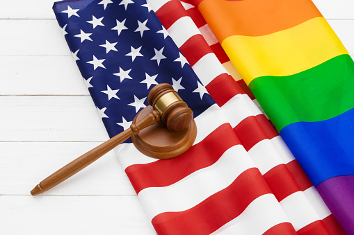 Image of a LGBT rainbow flag and American Flag. Gay pride