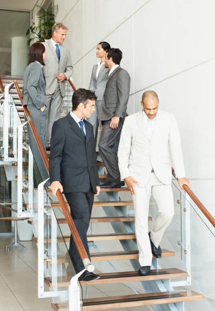 istock Business colleagues walking down stairs 173942593