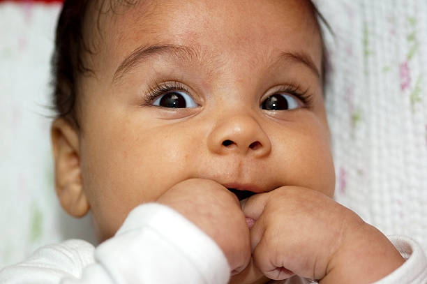retrato de niña bebé con los dedos en la boca - finger in mouth fotografías e imágenes de stock