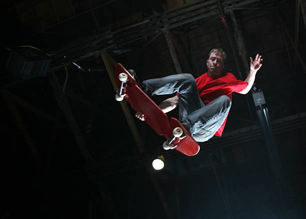 Skateboarder doing a jump in the air. Copy Space Available A low angle view of a skateboarder in the middle of a jump. Slight motion blur. extreme skateboarding stock pictures, royalty-free photos & images