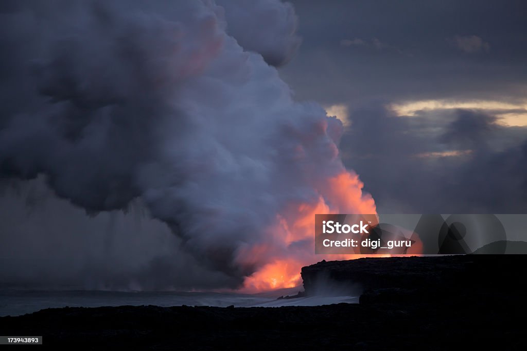 Hawaiian Volcano Kilauea Erupts Lava into The Pacific Ocean Kilauea, one of the world's most active volcano's erupts and spews lava into the cool waters of the Pacific Ocean at night in this time-exposure on the big island of Hawaii near Hilo. Ancient Stock Photo