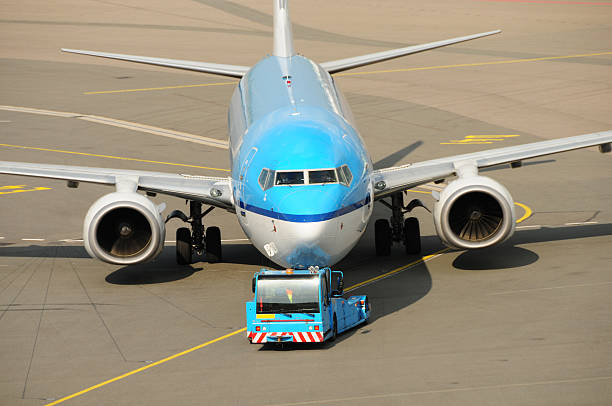 An airplane being towed to the runway for take-off.