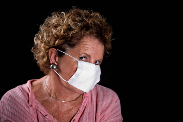 istock flu face mask on Senior woman 173944413