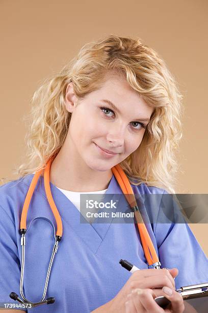 Attractive Medical Professional On Light Brown Stock Photo - Download Image Now - Adult, Adults Only, Beautiful People
