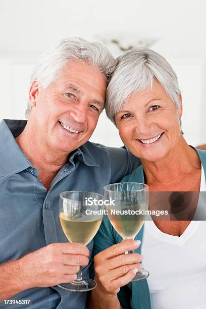 Retired Couple Enjoying A Glass Of Champagne Stock Photo - Download Image Now - 60-64 Years, 60-69 Years, Active Seniors