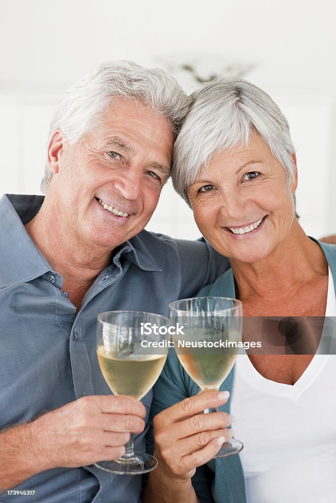 Отставке пара, наслаждаясь бокалом шампанского - Стоковые фото 60-64 года роялти-фри