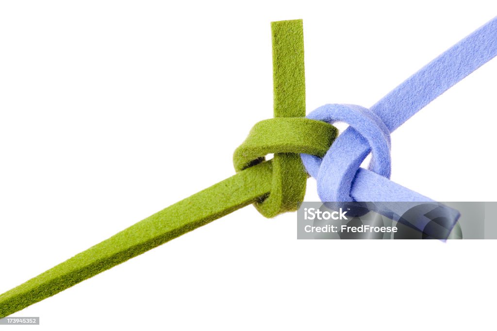 Teamwork "Knot close up, isolated on white,  focus on knot, soft focus on bands, concept for teamwork, relationship and networking" Agreement Stock Photo