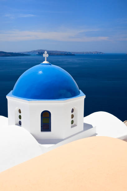 Famous Orthodox church with blue dome in village Oia (Ia) on Santorini island. Click for more images: