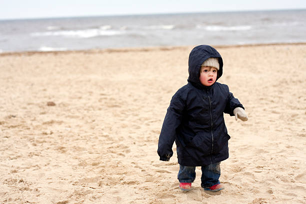 Boy walking at the beach