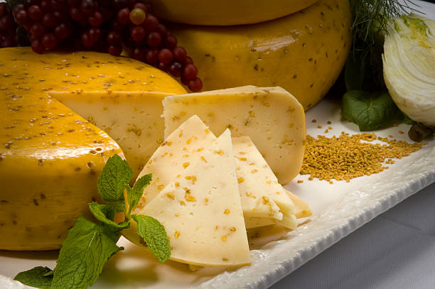 Sliced Cheese Wheel "Gouda cheese with cumin or mustard seeds, served on a tray for a party." gouda south holland stock pictures, royalty-free photos & images