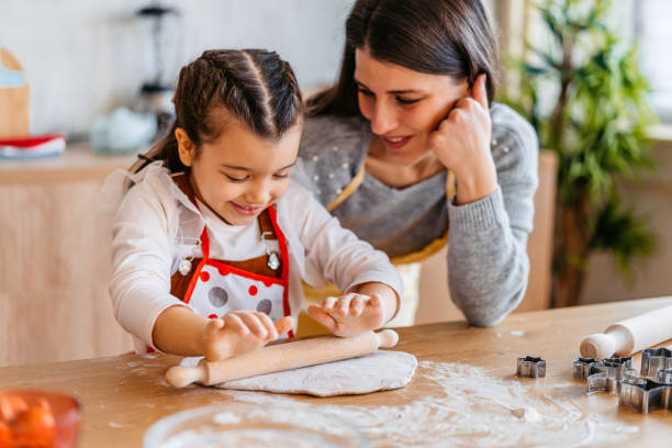 istock Girl Rolling A Dough For Christmas Cookies 1739471535