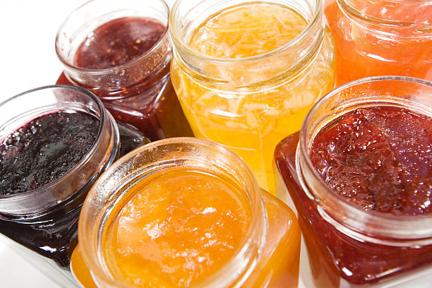 Six different varieties of jams in mason jars a selection of fruit jams and marmalades raspberry jam stock pictures, royalty-free photos & images