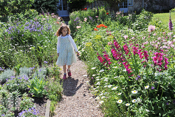 A seven year old girl in an English Country Garden in mid-summer
