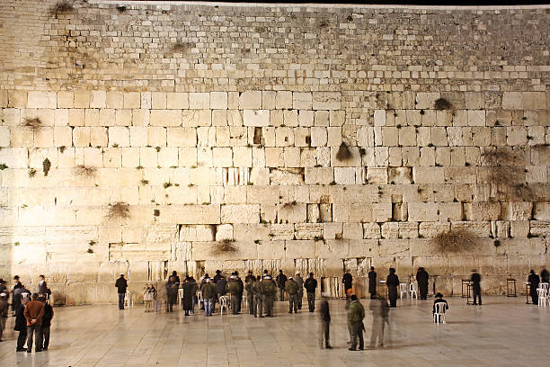 Western Wall "People, mostly soldiers praying at the holiest Jewish site - Western/Wailing wall at night" soldier on the wall stock pictures, royalty-free photos & images