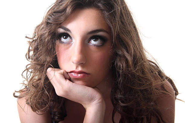 Bored Teenager Beautiful teenager looking bored on a white background rolling eyes irritation displeased facial expression stock pictures, royalty-free photos & images