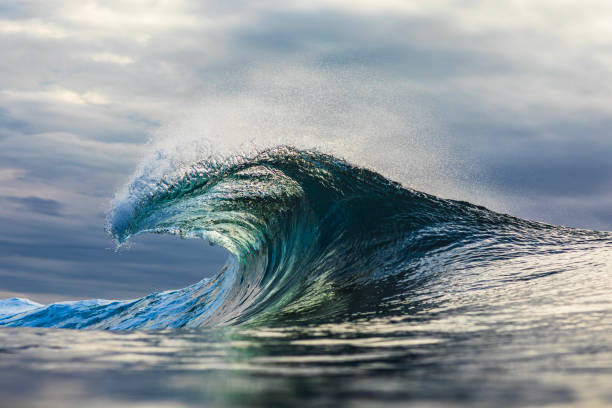 istock Powerful wave standing up in the ocean against a dark stormy sky 1739489290