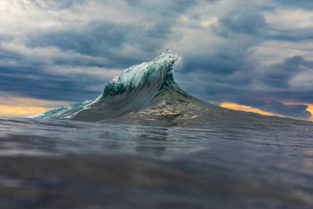istock Unique wave flaring up in the ocean against a dark stormy sky 1739490965
