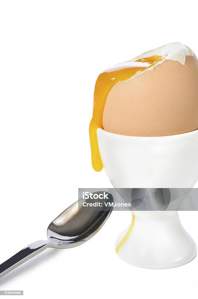 Dribbling Boiled Egg in Cup Soft boiled egg in a cup with a teaspoon. On white. Beauty Stock Photo