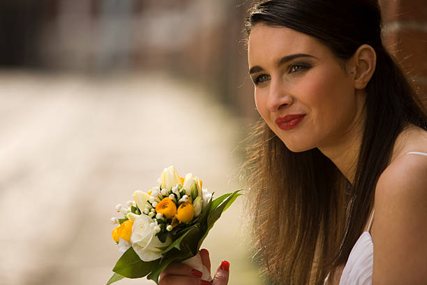 istock Young Bride with wedding flowers 173949311