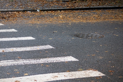 A white painted line marks the edge of the street, curving along the curb: side walk