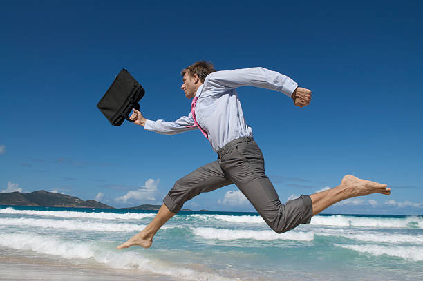 istock Businessman Rushes with Big Leaps on Tropical Beach 173949858