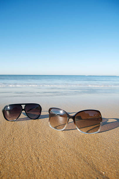 istock His and Hers Sunglasses on the Beach 173950177