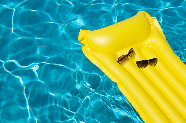istock His and Hers Sunglasses on Pool Raft 173950245