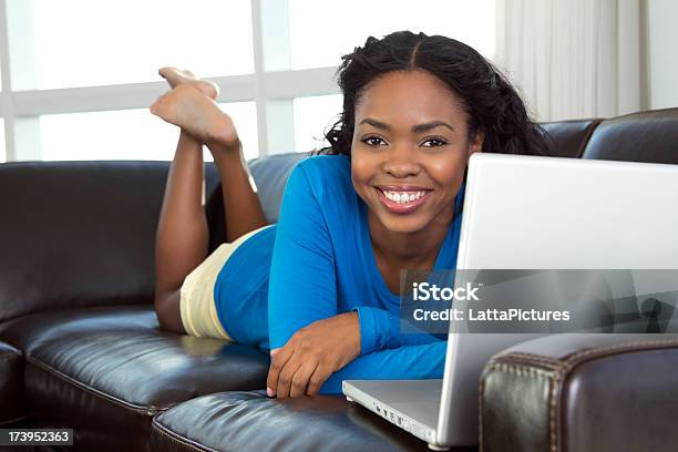 Africanamericanon Female On Sofa Using Laptop Stock Photo - Download Image Now - Adult, Adults Only, African Ethnicity
