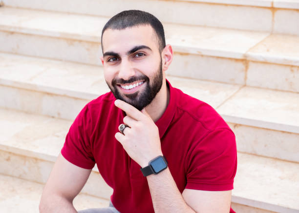 istock Portrait for man sitting on stairs while smiling 1739529395