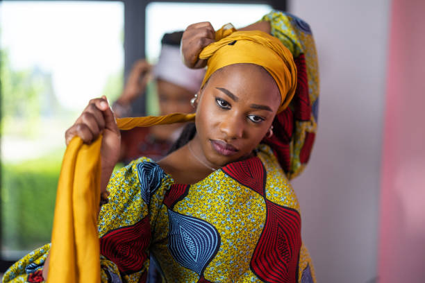istock Black woman putting on a headscarf 1739531491
