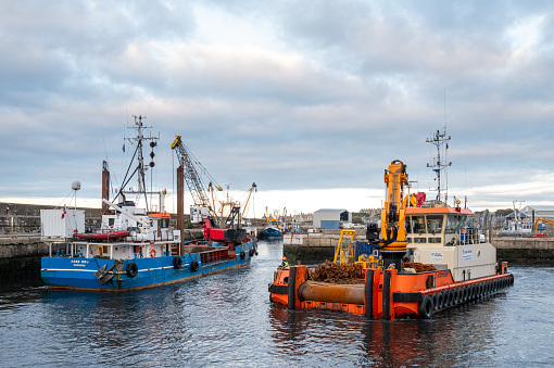 16 October 2023. Buckie Harbour,Buckie,Moray,Scotland. This is a Dredger Boat and a small offshore supply boat with chains.