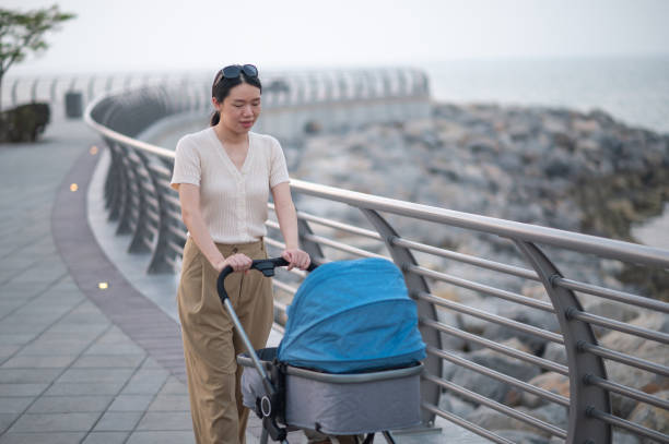 istock Mother pushing a blue-gray baby stroller 1739589804