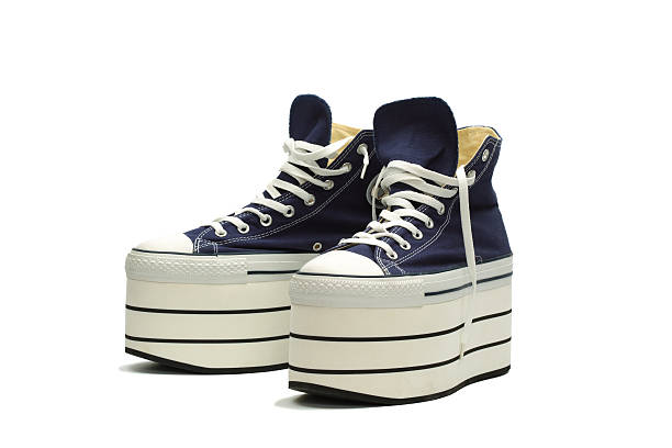 Blue platform sneakers with white laces 1990s platform canvas sneakers, isolated with clipping path platform shoe stock pictures, royalty-free photos & images