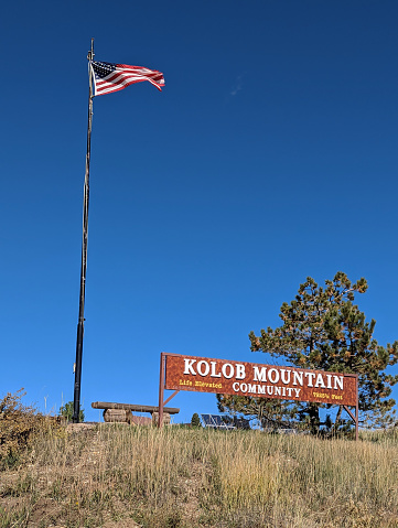 Town Sign and Flag Kolob Mountain in a mountain meadow.