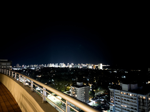 View of the city from the public space on the roof of the apartment complex. Night illumination