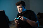 young man playing console game