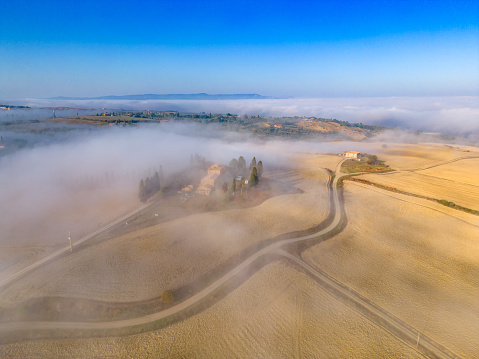 Foggy landscape in Val d'Orcia from drone