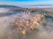 San Quirico d'Orcia in fog, Tuscan town in Val d'Orcia