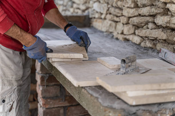 istock DIY home improvement. Man building stone barbeque. 1739697950